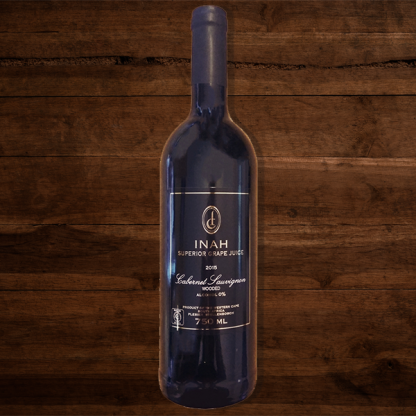 The Red Vintage Cabernet Sauvignon Inah Superior Grape Juice Bottle on Dark Wood